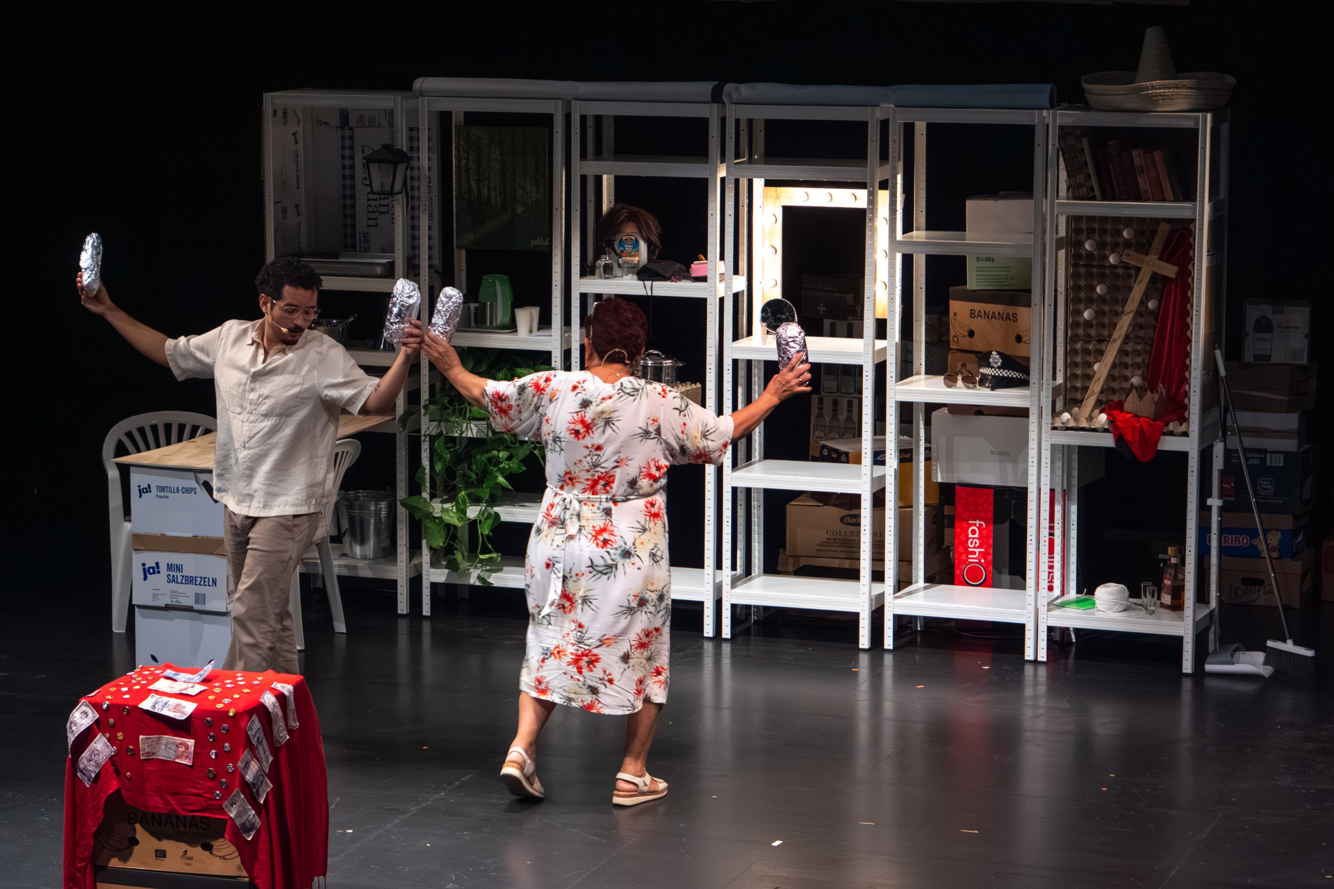 Josefina Orlaineta and Anacarsis Ramos, mother and son, move around the stage, arms outstretched, holding sandwiches wrapped in aluminum foil.