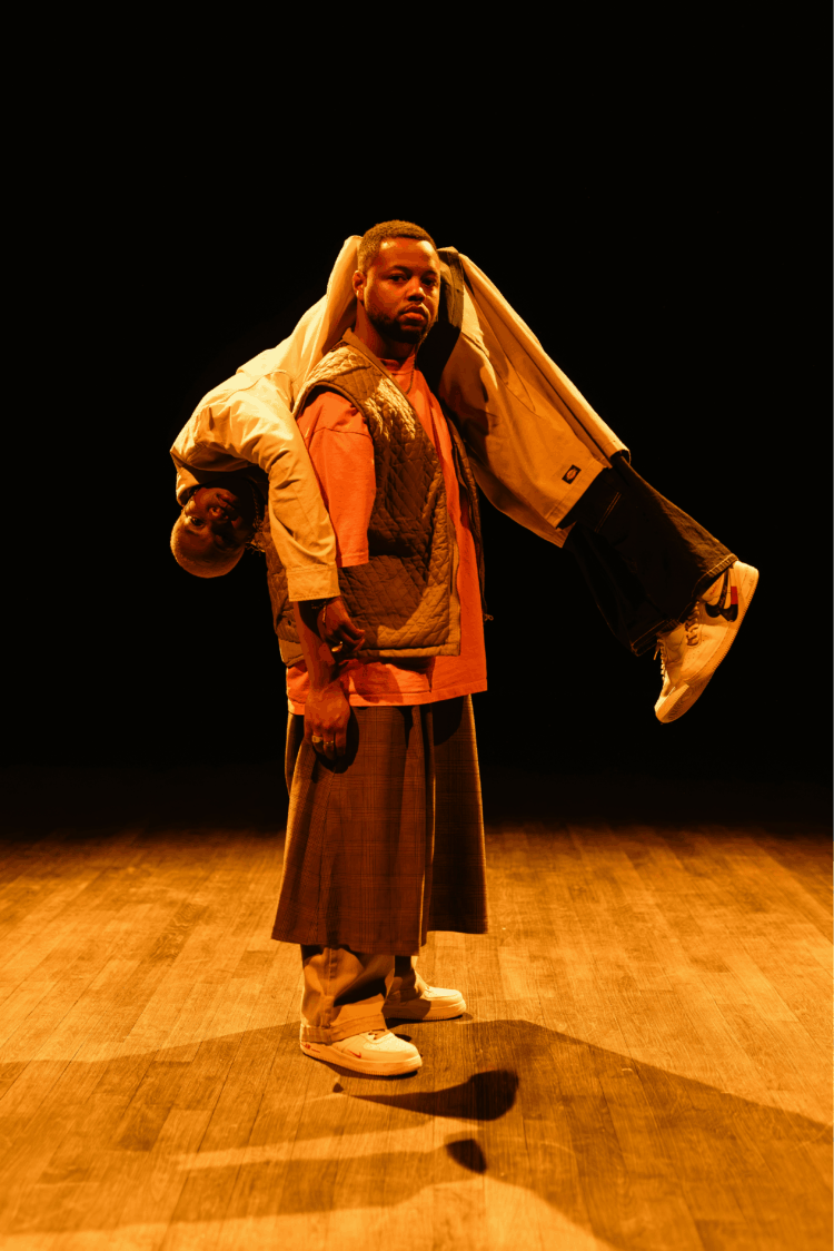 One interpreter carries another on his shoulder like a sack of potatoes.