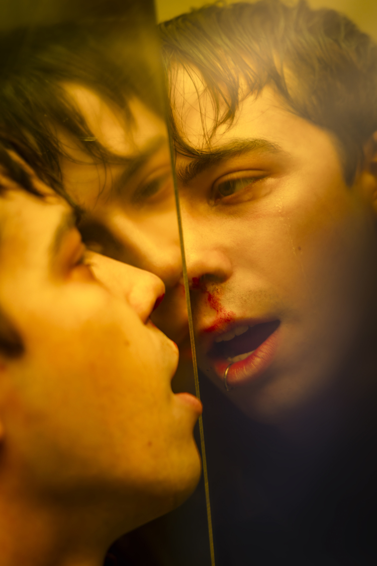 A character looks at himself in a mirror that duplicates his face