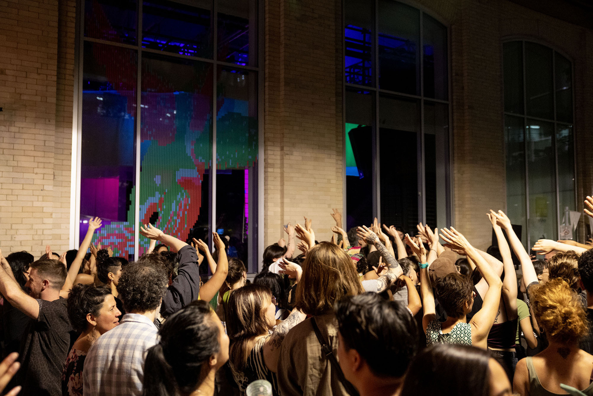 A crowd of people dance outside the FTA headquarters.